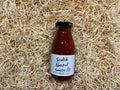 Bottle of Scotch Bonnet sauce on a bed of straw