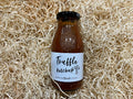 Bottle of truffle ketchup on a bed of straw
