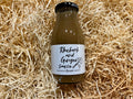 Bottle of Rhubarb and Ginger Sauce on a bed of straw