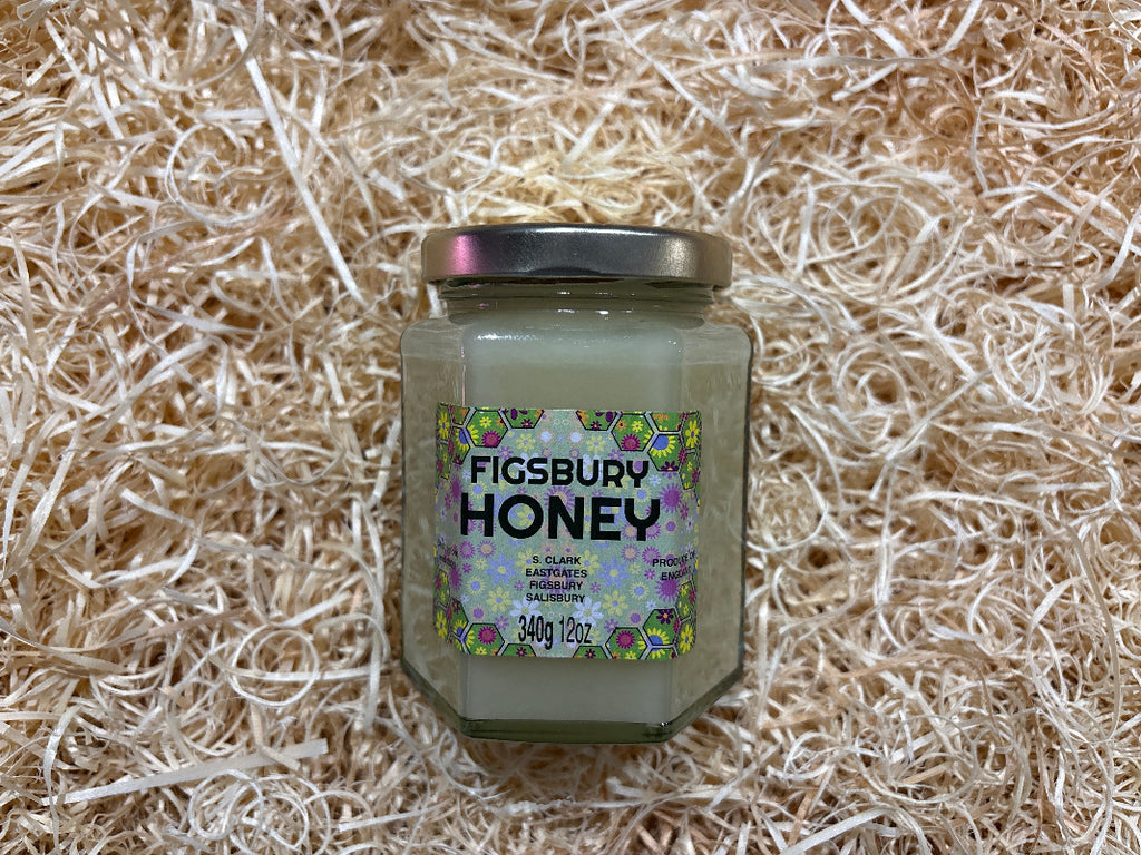 Jar of Figsbury Honey on a textured beige background