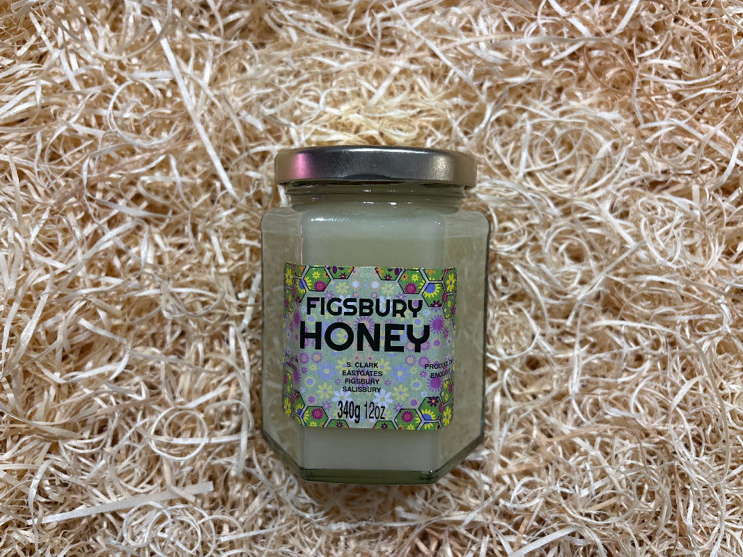 Jar of Figsbury Honey on a textured beige background