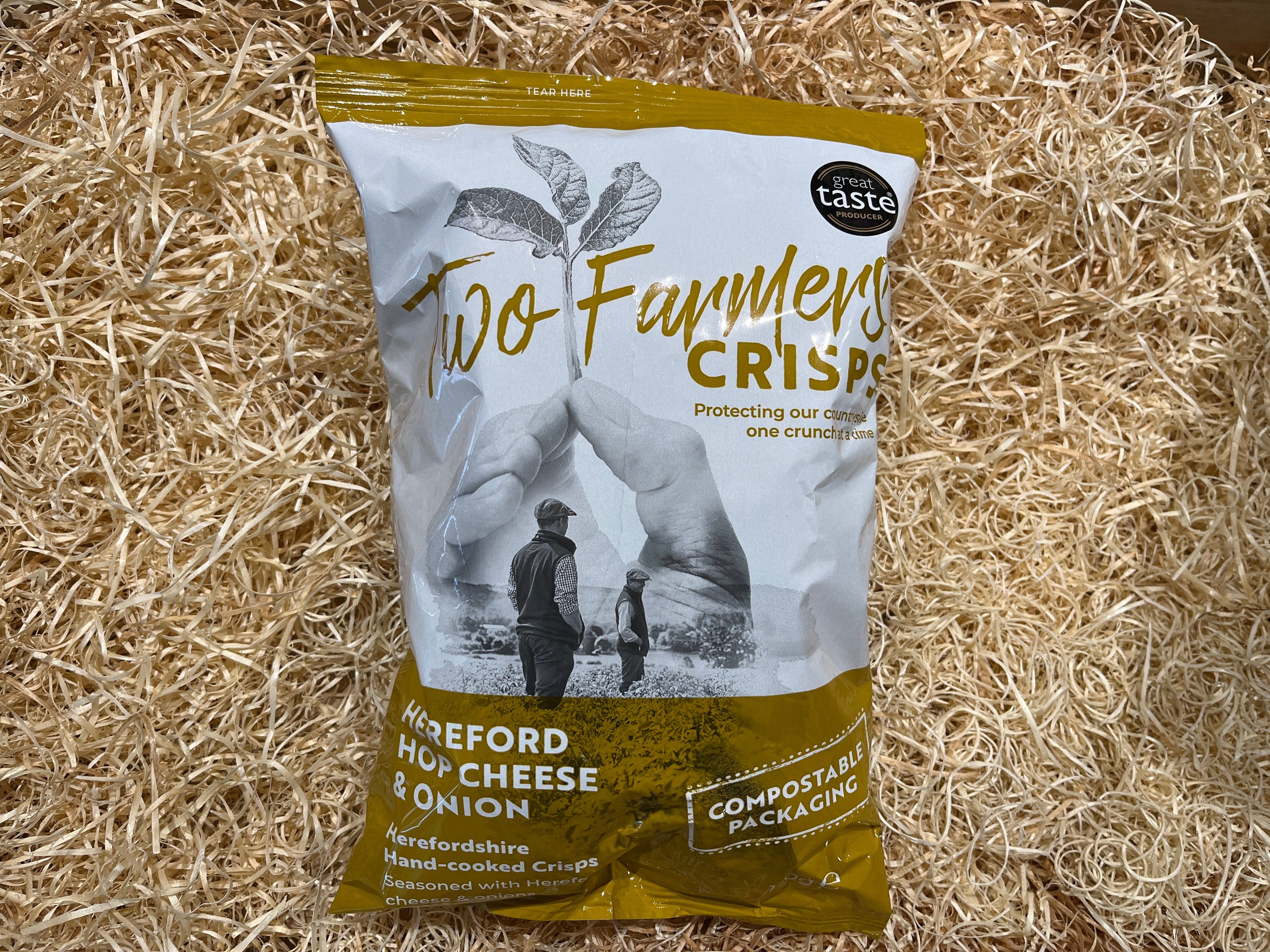 Two Founder's Crisps package on a straw background