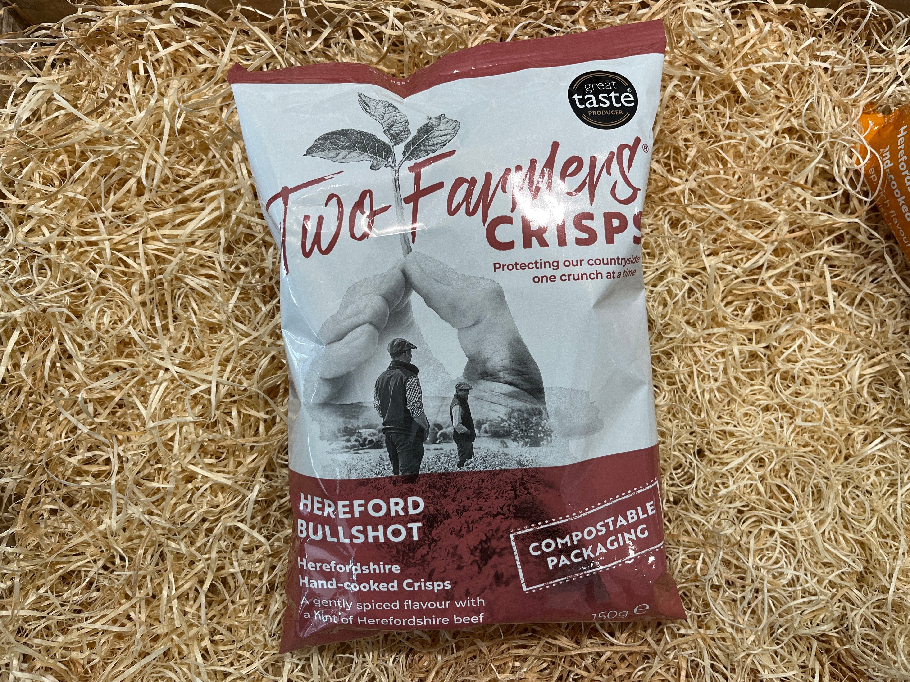 Two Farmers Crisps package on a bed of straw