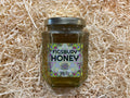 Jar of Figsbury Honey on a bed of straw