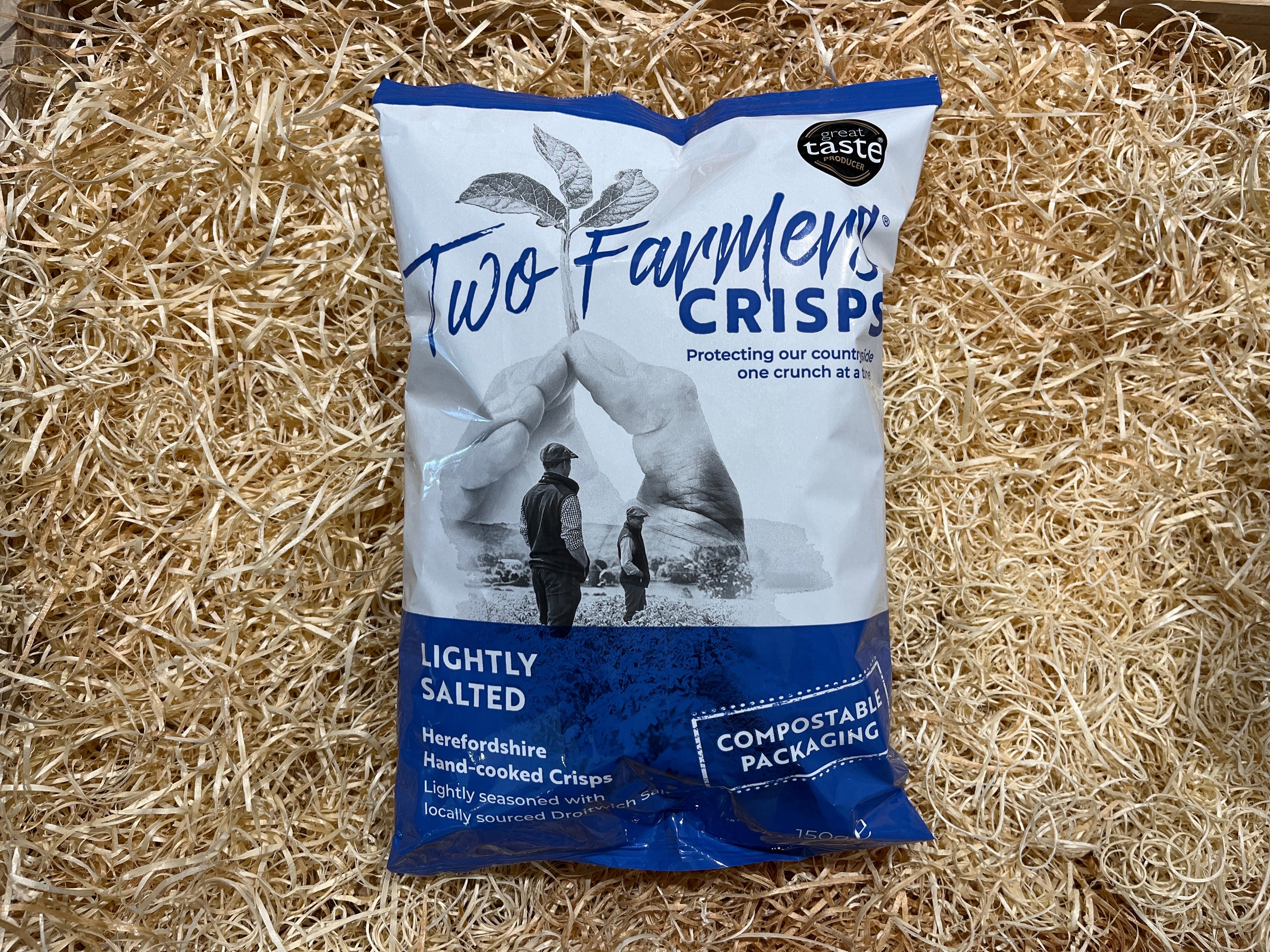 Two Farmers Crisps packet on a straw background