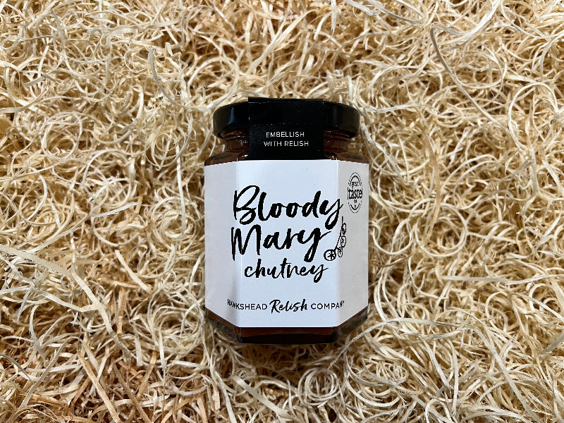 Jar of Bloody Mary chutney on a bed of straw