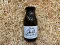 Bottle of Sticky Chilli Marinade on a bed of straw