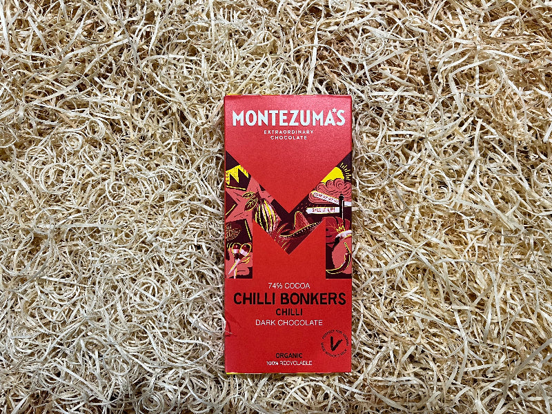 Montezuma's Chilli Bonkers chocolate bar packaging on a textured beige background
