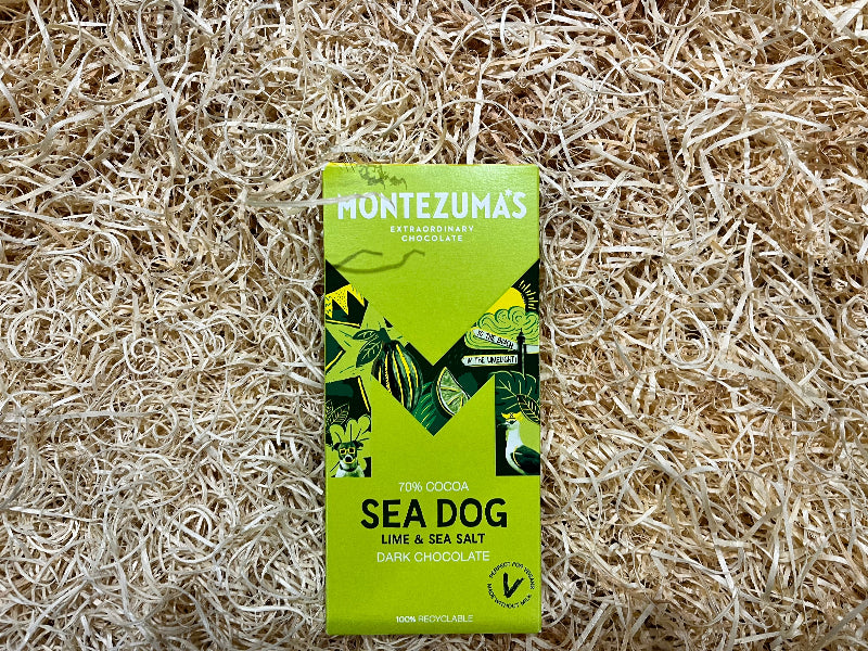 Montezuma's Sea Dog chocolate bar packaging on a natural straw background