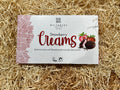 Whitaker's Strawberry Creams chocolate packaging on a straw background