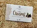 Whitaker's Coffee Creams chocolate packaging on a straw background