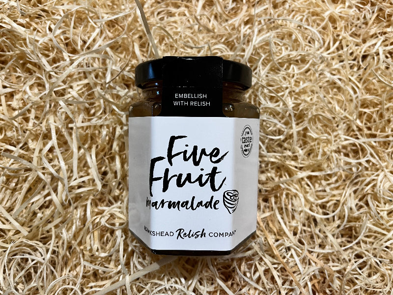 Jar of Five Fruit Marmalade on a bed of straw