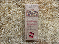 Box of Miller's Toast cranberry & raisin gluten-free crackers on a straw background
