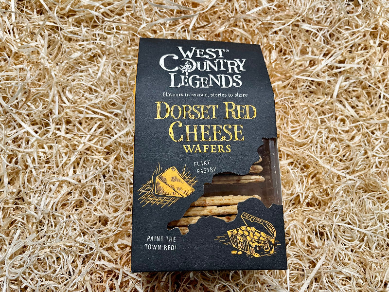 Pack of Dorset Red Cheese Wafers from West Country Legends on a straw background