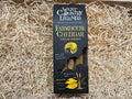 West Country Legends Farmhouse Cheddar Cheese Straws packaging on a bed of straw.