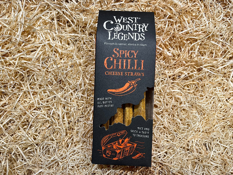 Box of West Country Legends Spicy Chilli Cheese Straws on a straw background
