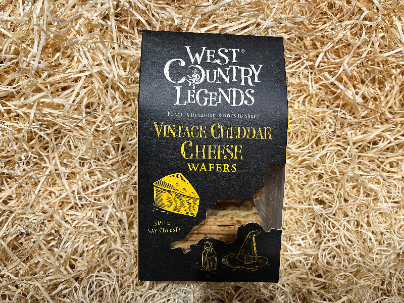 Packaging of West Country Legends Vintage Cheddar Cheese Wafers on a straw background