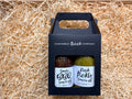 Two bottles of Hawkeshead Relish Company sauces in a black carrier box on straw.